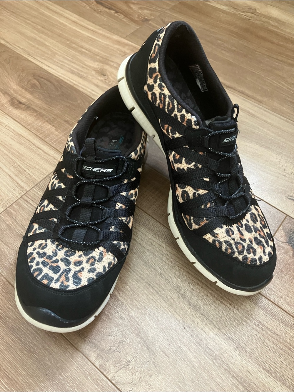 Skechers Women's Leopard Print Slip-On Sneakers in Black and Tan